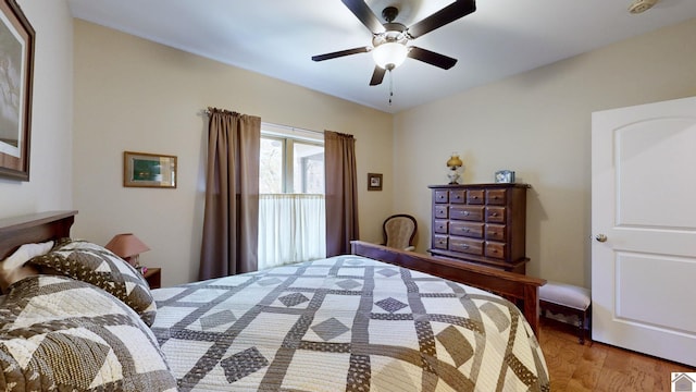 bedroom with ceiling fan and wood-type flooring