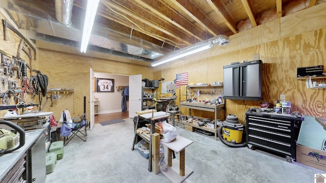 miscellaneous room featuring concrete flooring and a workshop area