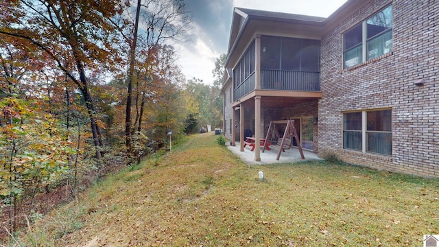 view of yard with a patio and a sunroom