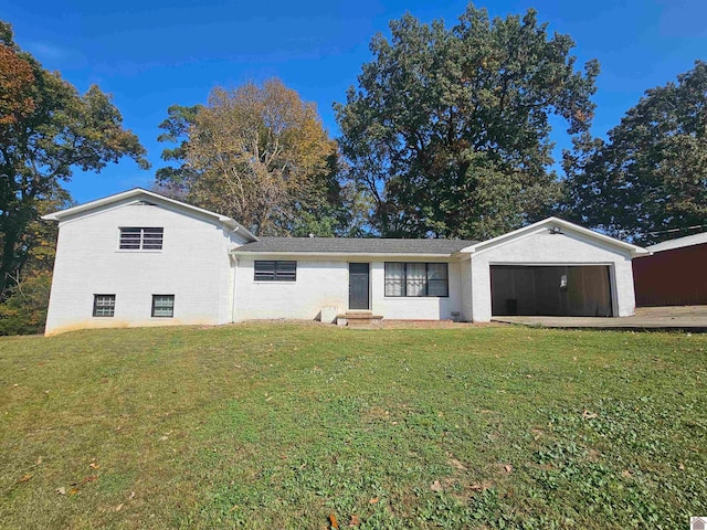 view of front of home with a front yard and a garage