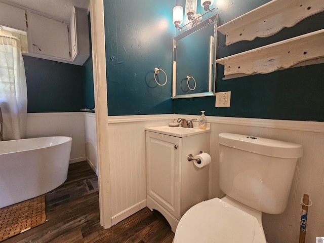 bathroom with vanity, toilet, wood-type flooring, and a tub