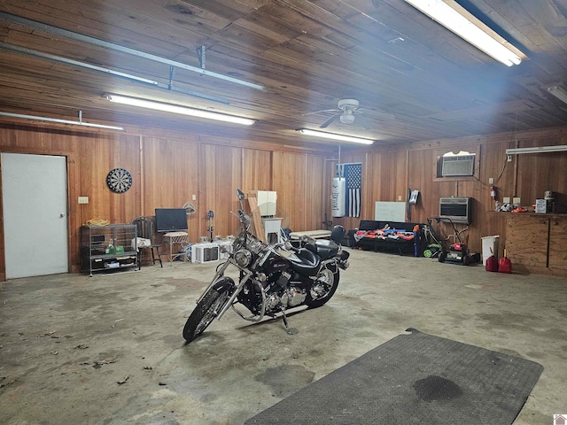 garage with ceiling fan, wooden walls, and an AC wall unit