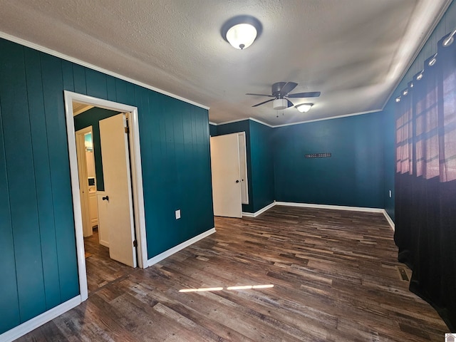 spare room with ornamental molding, a textured ceiling, ceiling fan, and dark hardwood / wood-style flooring