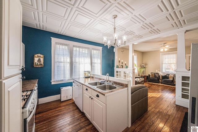 kitchen featuring dark wood-type flooring, decorative light fixtures, white cabinets, white appliances, and ceiling fan