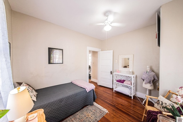 bedroom with dark hardwood / wood-style flooring and ceiling fan