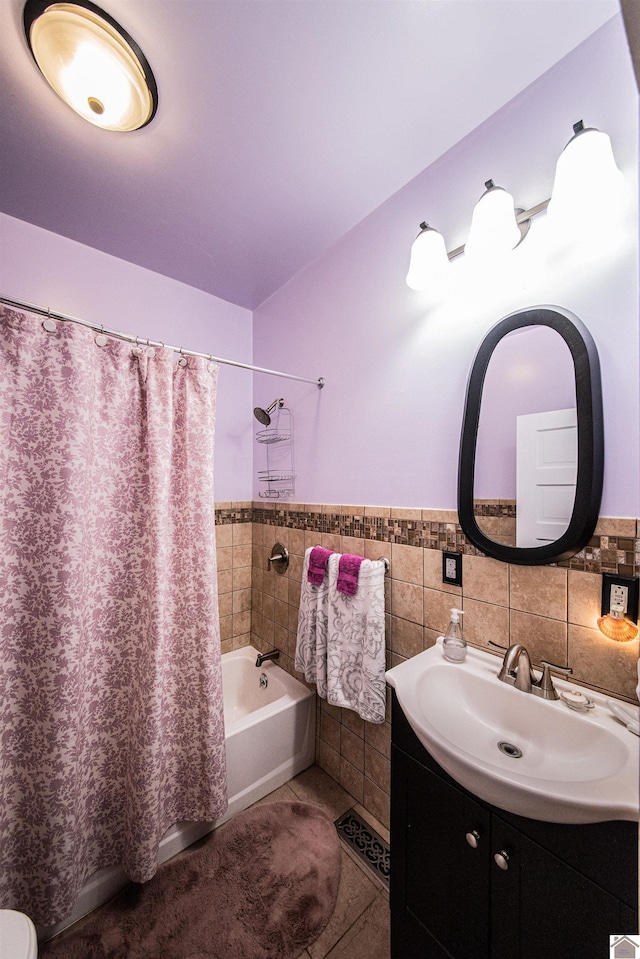 bathroom featuring tile walls, vanity, tile patterned flooring, and shower / bathtub combination with curtain