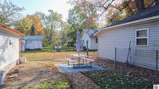 view of yard with a storage shed and a patio area