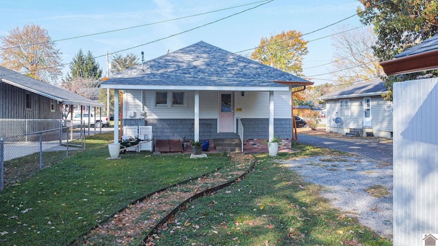 bungalow with a front lawn and covered porch