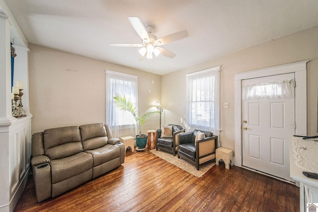 living room featuring ceiling fan and hardwood / wood-style floors