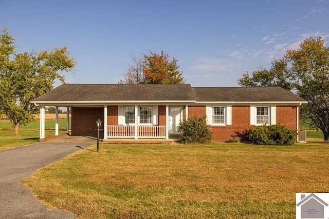 single story home featuring covered porch, a carport, and a front yard