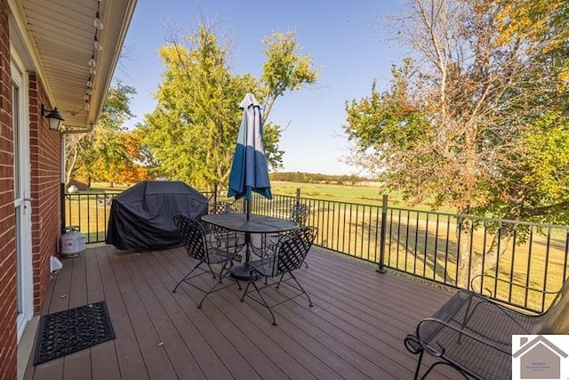 wooden terrace with a grill