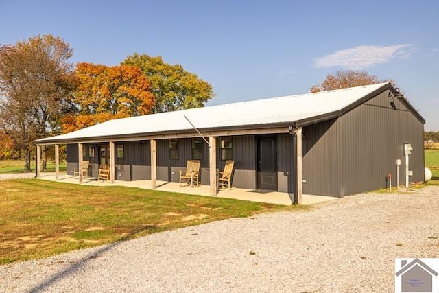 rear view of house featuring a patio area and a lawn