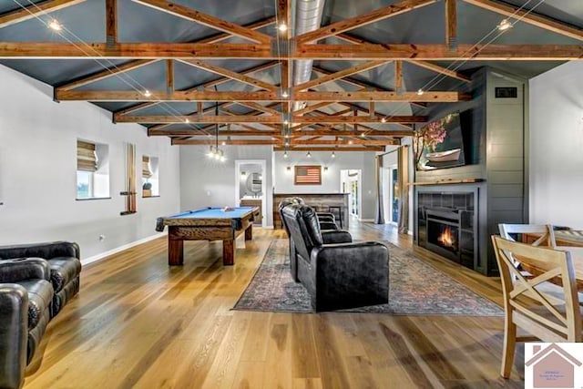 rec room with billiards, lofted ceiling with beams, light hardwood / wood-style flooring, and a tile fireplace