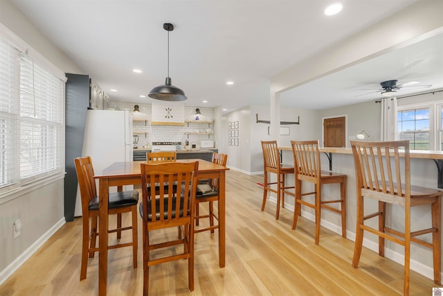 dining room featuring light hardwood / wood-style flooring and ceiling fan