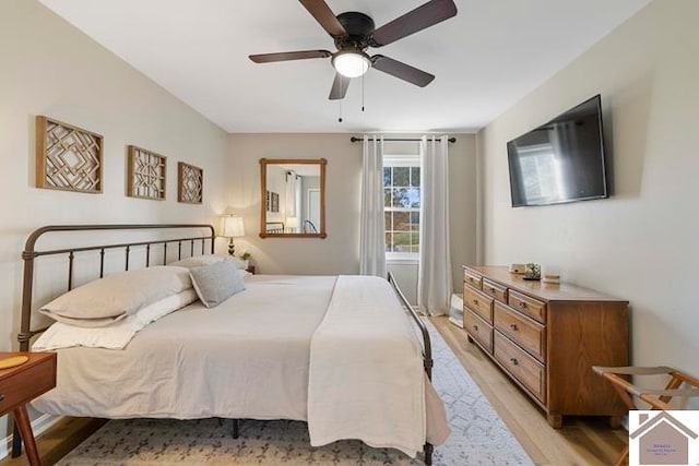 bedroom with ceiling fan and light hardwood / wood-style flooring