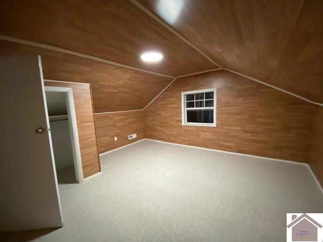 bonus room featuring wood ceiling, lofted ceiling, and wooden walls