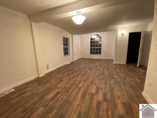 spare room featuring dark wood-type flooring