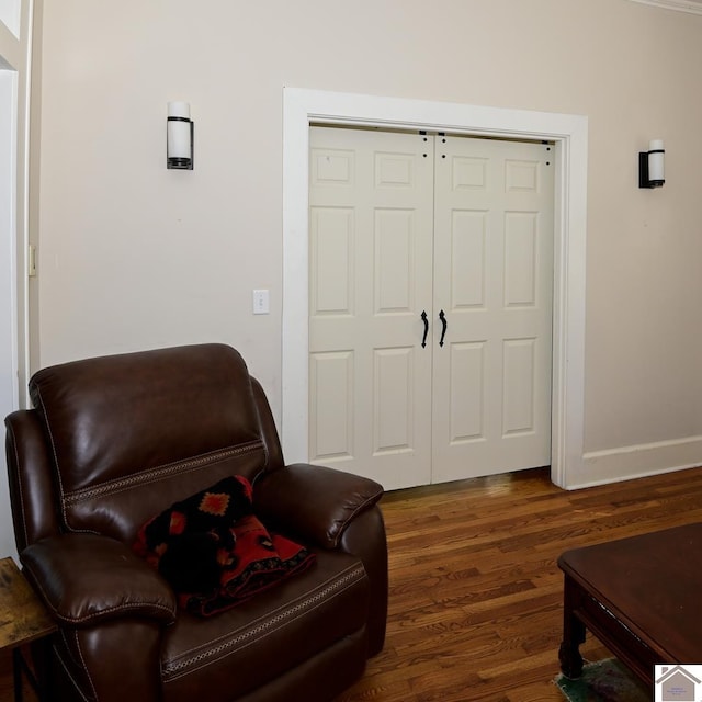 sitting room with dark wood-type flooring