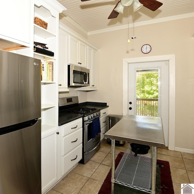 kitchen featuring crown molding, appliances with stainless steel finishes, and white cabinets