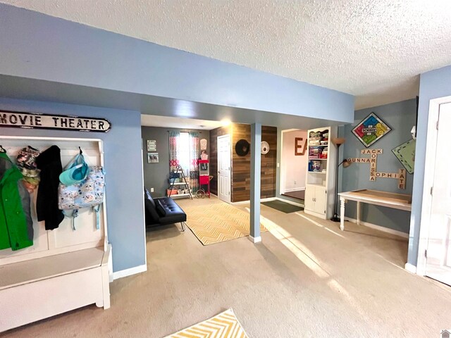 interior space featuring carpet and a textured ceiling