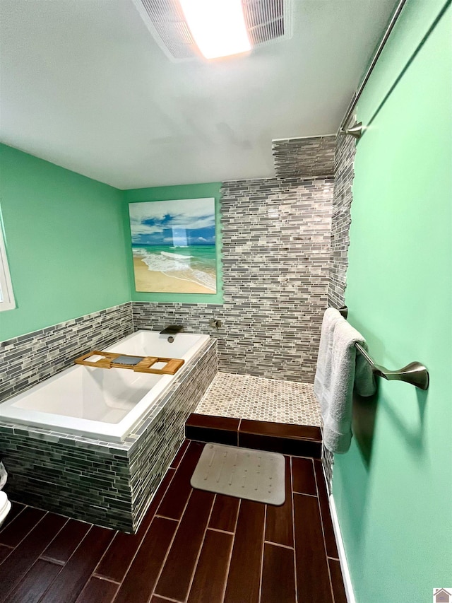 bathroom with shower with separate bathtub