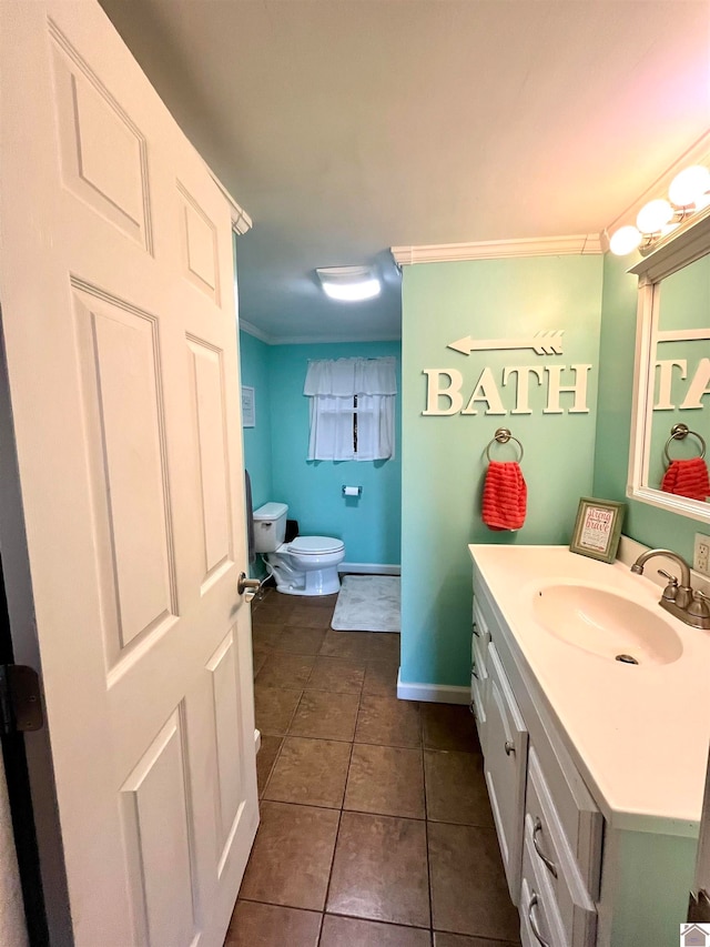 bathroom featuring tile patterned floors, vanity, toilet, and crown molding