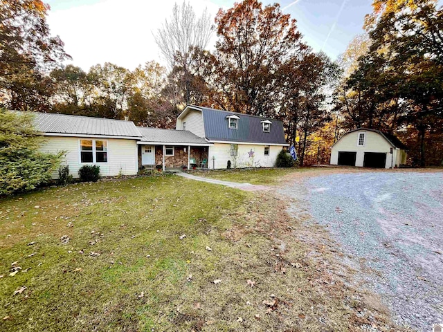 view of front of house with an outbuilding, a garage, and a front yard