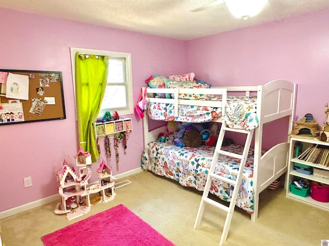 bedroom featuring ceiling fan, carpet floors, and a textured ceiling