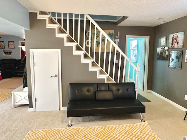 staircase featuring a textured ceiling and carpet floors