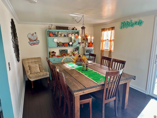 dining space featuring dark hardwood / wood-style flooring, ornamental molding, and a chandelier