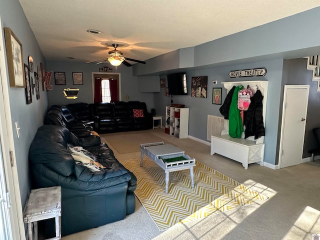 carpeted living room with a textured ceiling and ceiling fan