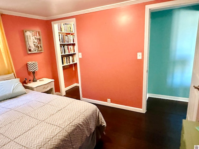 bedroom with crown molding and hardwood / wood-style flooring