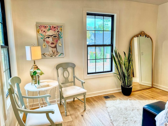 sitting room with wood-type flooring