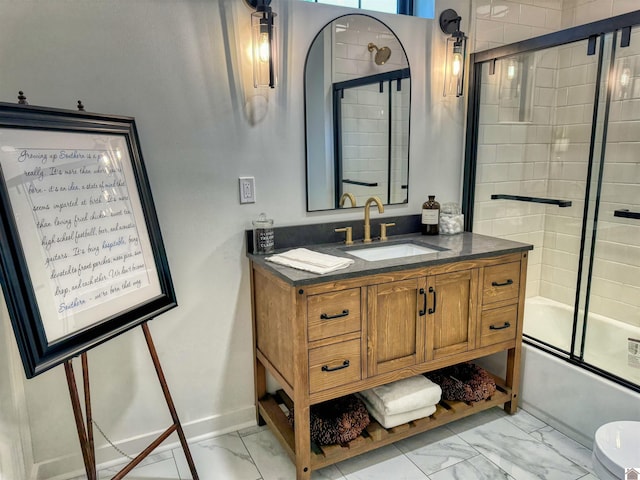 full bathroom with combined bath / shower with glass door, vanity, and toilet