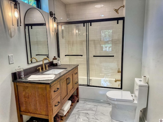 full bathroom with vanity, enclosed tub / shower combo, and toilet