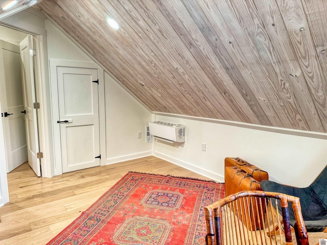 bonus room with a wall mounted air conditioner, light hardwood / wood-style floors, and lofted ceiling