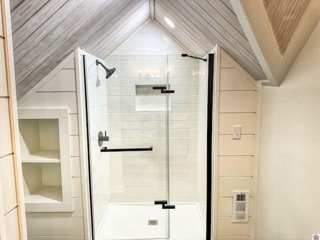 bathroom featuring vaulted ceiling and a shower with door