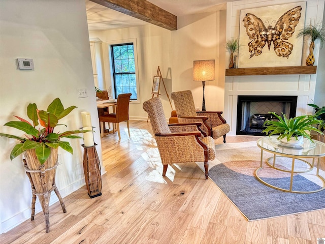 living area featuring light hardwood / wood-style floors and beam ceiling