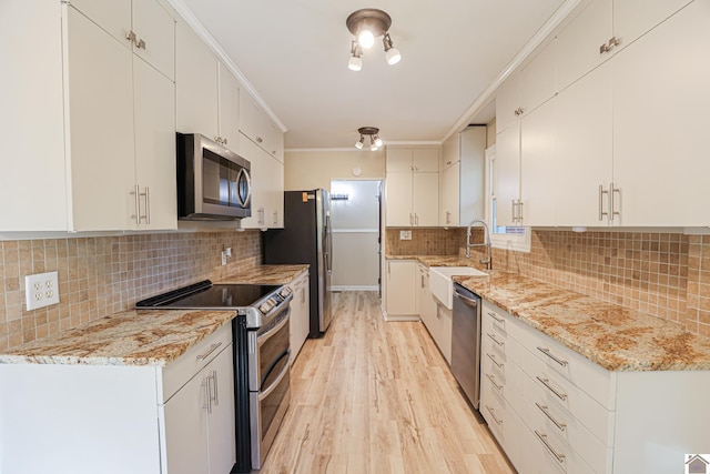 kitchen featuring light hardwood / wood-style floors, stainless steel appliances, sink, and white cabinets