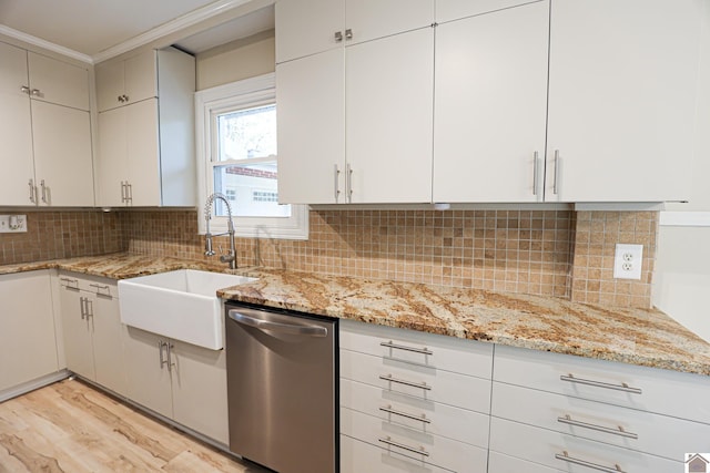 kitchen featuring light hardwood / wood-style floors, sink, stainless steel dishwasher, and white cabinets