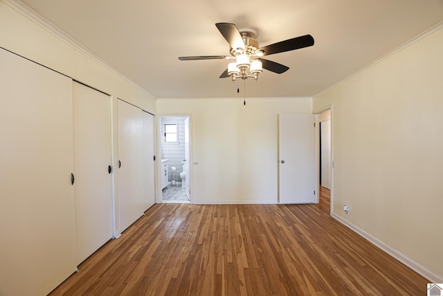 unfurnished bedroom featuring ornamental molding, wood-type flooring, and ceiling fan