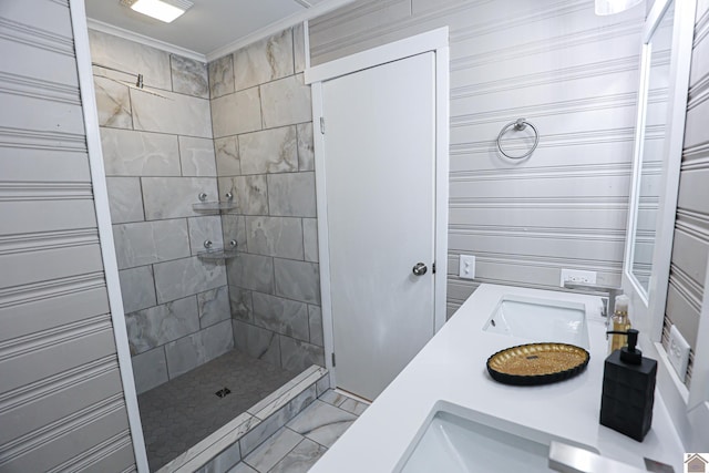 bathroom featuring vanity, ornamental molding, and tiled shower