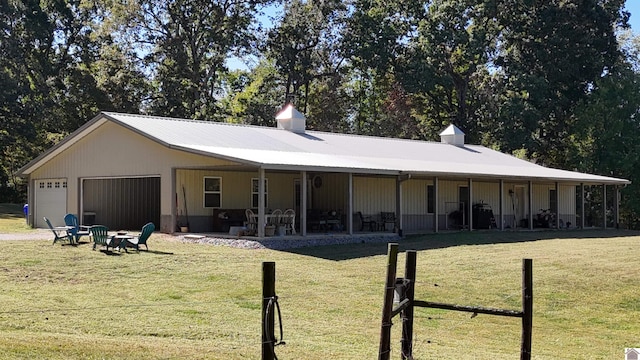 view of front facade with a patio, a front lawn, and a garage