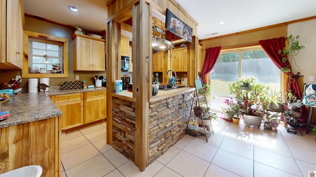 kitchen with crown molding, light tile patterned flooring, and light brown cabinets