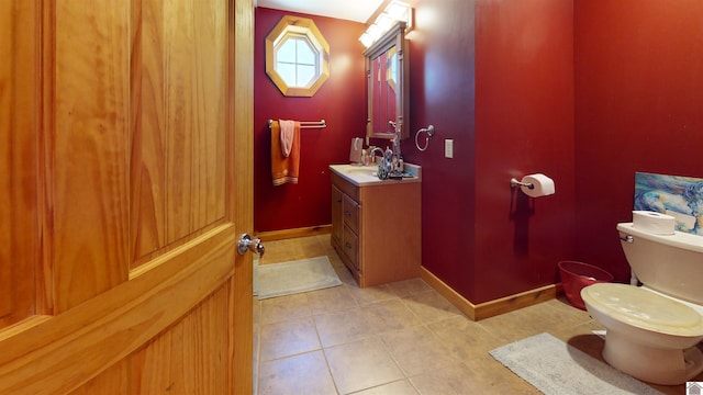 bathroom featuring vanity, toilet, and tile patterned floors