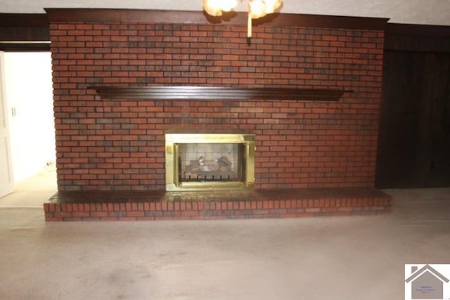 interior details with a brick fireplace and ceiling fan