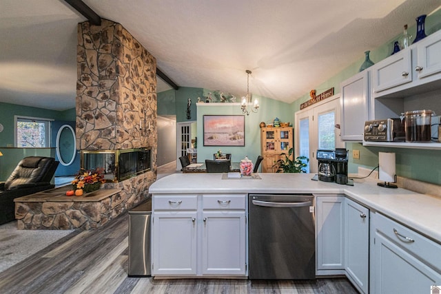 kitchen featuring dishwasher, light hardwood / wood-style flooring, vaulted ceiling with beams, and pendant lighting