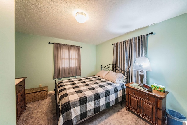 bedroom featuring a textured ceiling and light colored carpet