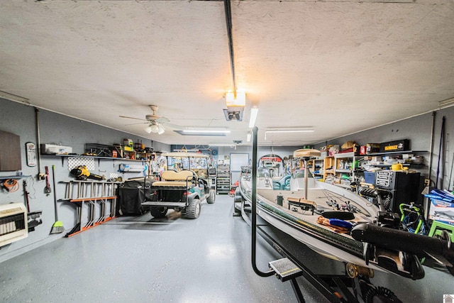 garage featuring heating unit, a workshop area, and ceiling fan