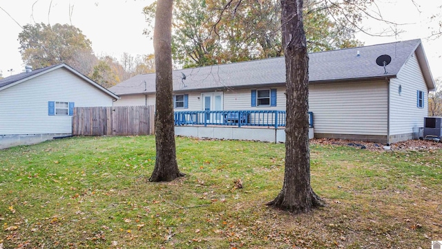 rear view of property with central AC, a yard, and a deck